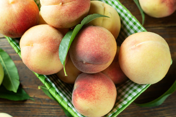 Naklejka na ściany i meble fresh rosy peaches in a basket