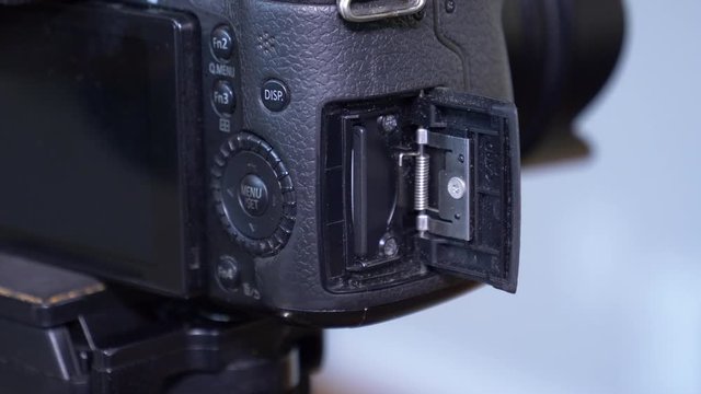 Inserting and removing a 128GB SD card for a camera 4K