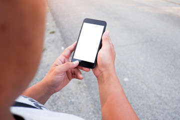 Cropped shot view of business woman’s hands holding the mobile phone with blank copy space screen for your information content or text message, the woman reading text message on the smart phone during