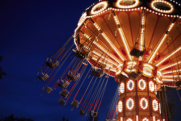 Carousel Merry-go-round in amusement park at a night city