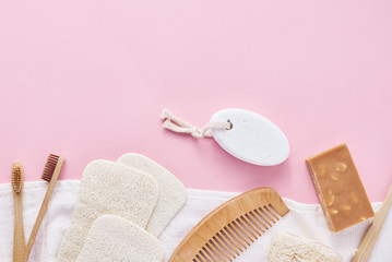 Body care natural wooden eco friendly products on a pink background, flat lay top view with copy...
