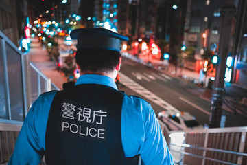 Tokyo police officer at night
