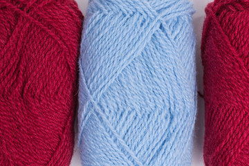 background of balls of shetland wool in red and blue