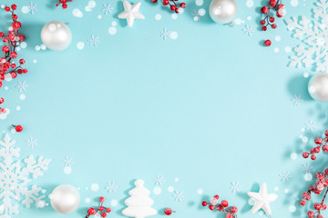 Christmas holiday composition. White branches, decoration, red berry on pastel blue background. Christmas, New Year, winter concept. Flat lay, top view, copy space