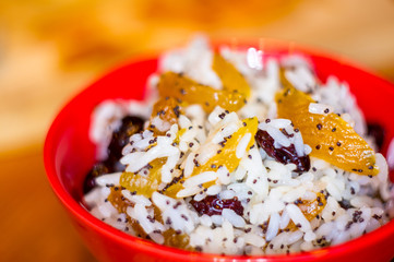 handmade preparation of treats for traditional Orthodox Christmas - rice pudding with fruits, cranberries, honey, nuts, Church candles