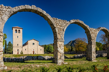 San Vincenzo al Volturno, a Benedictine monastery in Castel San Vincenzo and Rocchetta a Volturno. The new abbey. The remains of walls of an ancient building, with a series of stone arches.