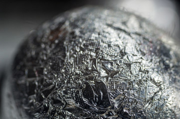 Unusual abstract techno view of crumpled aluminum foil ball, close-up, macro photography