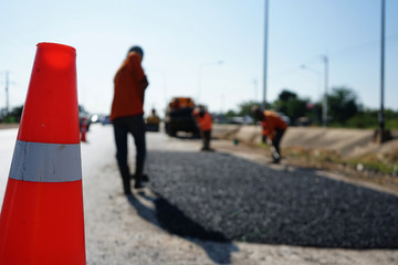 Workers fixing the road Adjusting with asphalt material (blurred image)