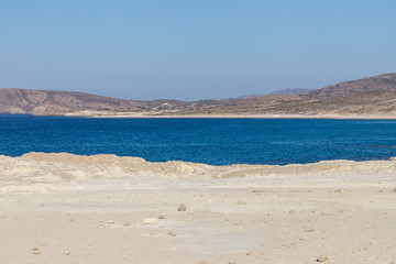 Shoreline of Mytakas beach with mountains