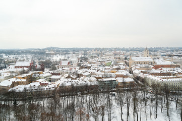 Obraz na płótnie Canvas Winter snowy day in Vilnius, Gediminas Tower with view of the River and the embankment.