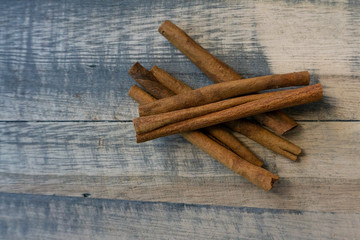 Cinnamon sticks on a wooden background