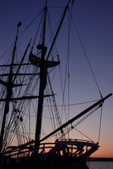 A sailing ship docked at Penn Cove on Whidbey Island, Washington. This vertical format image...