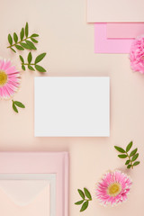 flatlay paper card floral pink peach pastel gerbera flower leaves petals cards wedding invitation top view