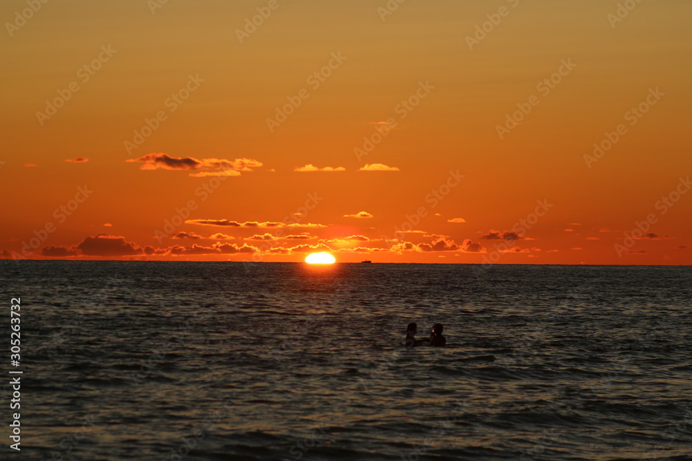 Sticker the sun setting over the ocean