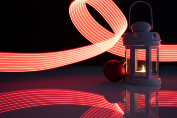 Świąteczna latarenka z Bożonarodzeniową bombką na czarnym i malowanym światłem tle © andsko