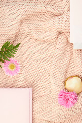 cozy wool blanked sweater pink peach pastel flatlay top view flower greenery planner book light feminine