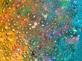 Colorful background of Christmas tree toys . Drops of water and oil