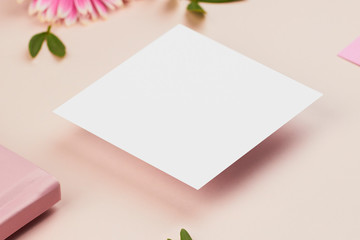 white paper mockup on peach background flower petal floral feminine pastel rose pink planner book envelope paper