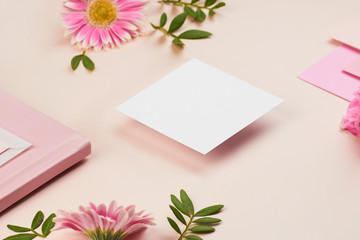 white paper mockup on peach background flower petal floral feminine pastel rose pink planner book envelope paper