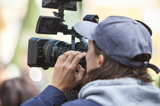 Man journalist with a modern large black video camera