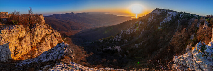 Fototapeta premium Rocky mountain range at sunrise, panorama