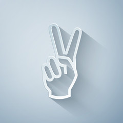 Paper cut Hand showing two finger icon isolated on grey background. Victory hand sign. Paper art style. Vector Illustration