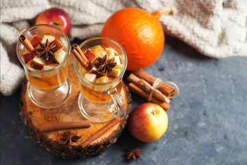 Hot autumn and winter alcoholic drink sangria or cider on the table with Apple, pumpkin, cinnamon, anise