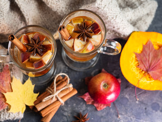 Hot autumn and winter alcoholic drink sangria or cider on the table with Apple, pumpkin, cinnamon, anise