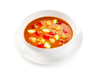 Tomato soup with carrot and zucchini on white background