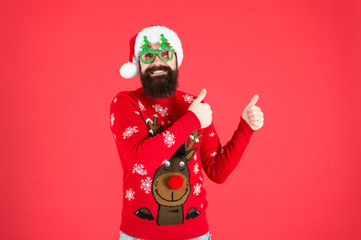 Nice choice. Sweater with deer. Knitted sweater. Happy new year. Christmas spirit. Funny outfit. Clothes shop. Buy festive clothing. Holidays accessories. Hipster bearded man wear sweater and hat