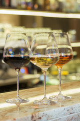 Red, rose and white wine in glasses on bar counter in the restaurant