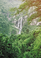 Fototapeta na wymiar Double waterfall Polikarya in summer mountains, Russia, Sochi.