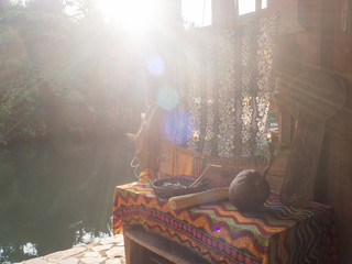 Authentic composition. An old table and old objects on it in the rays of the setting sun. Thailand