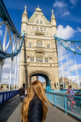 Woman pulling her boyfriend over the Tower of London Bridge