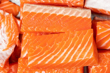 Medium pieces of salmon fillet top view, close up.