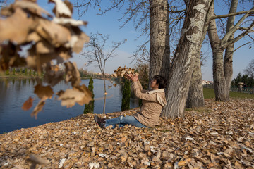 lonely and happy young woman  on autumn leaves