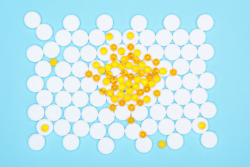 Fish oil omega-3 in yellow soft gelatin capsules pills arrange to be fish shape isolate  white background with copy space for text. Top view of fish oil for good health on white background from pills.