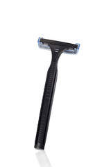 Black disposable plastic razor on white with reflection.