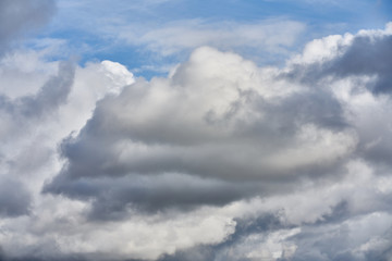 Blue sky and white fluffy clouds on sunset sky. White cumulus clouds. Dramatic sky and clouds abstract