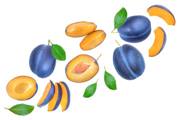 fresh blue plum and half with leaves isolated on white background. Top view. Flat lay