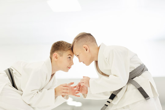 Two young karatekas in kimono fighting with each other during training in karate