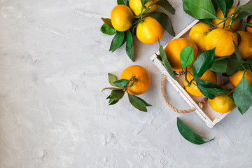 Fresh tangerines in white wooden tray