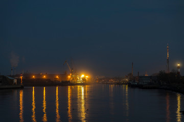 Fototapeta na wymiar in the evening, ship lights shine in the port