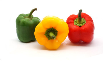 Fresh green, yellow and red bell peppers  on white background.
