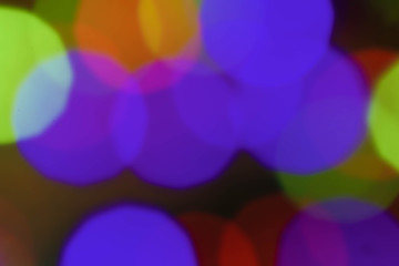 Abstract colorful bokeh blurred lights on a dark background