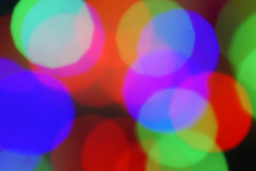 Abstract colorful bokeh blurred lights on a dark background