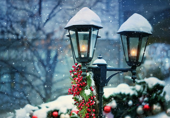 glowing decorated Christmas lantern outdoor, snowy nature background. Christmas, New year holidays...