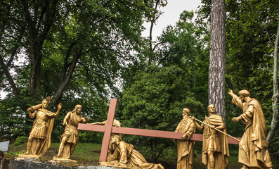 Obraz premium Lourdes, France, June 24 2019: Way of the Cross of Jesus, Station VII - second fall under the cross