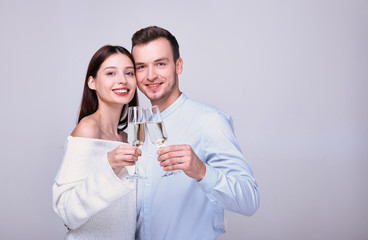 Elegant young couple holding a glass of champagne.