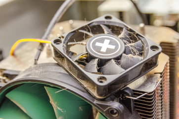 Dust, dirt on the CPU cooler of the computer with a fragment of the computer case close-up